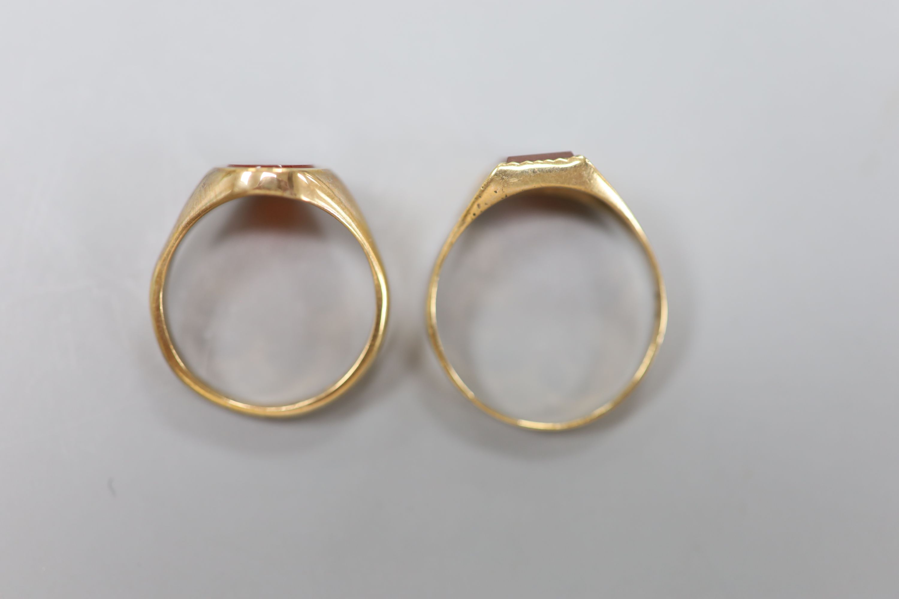 Two modern 9ct gold and carnelian set signet rings, sizes U & Q, gross 6.6 grams.
